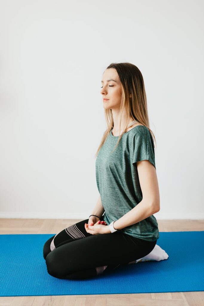 woman-kneeling-on-a-yoga-mat-4498216 Side view of young slim female in sportswear sitting in Virasana pose with closed eyes while practicing yoga at home